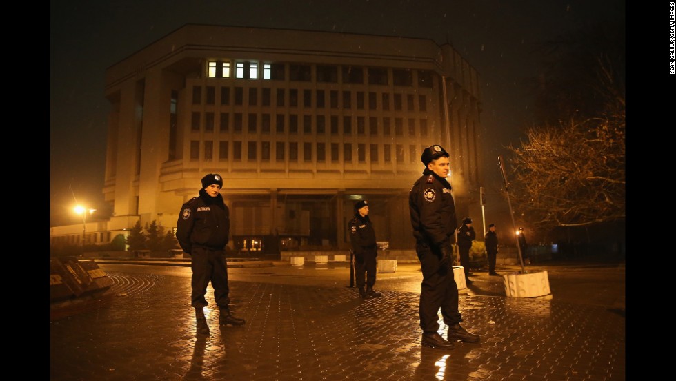 Police stand guard outside the Crimea regional parliament building Thursday, February 27, in Simferopol. Armed men seized the regional government administration building and parliament in Crimea. 