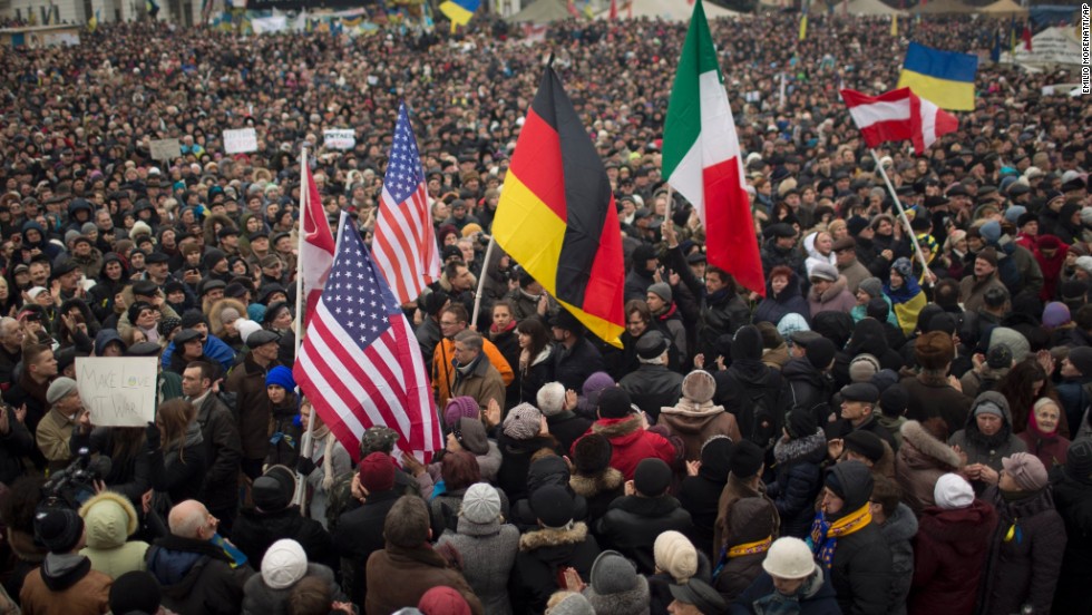 Protesters hold flags of the United States, Germany and Italy during a rally in Independence Square on March 2.