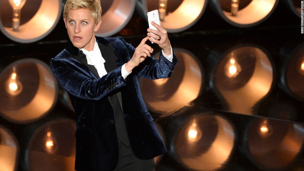 DeGeneres &lt;a href=&quot;https://twitter.com/TheEllenShow/status/440302561044594688&quot; target=&quot;_blank&quot;&gt;takes a selfie&lt;/a&gt; on stage near the start of the show.