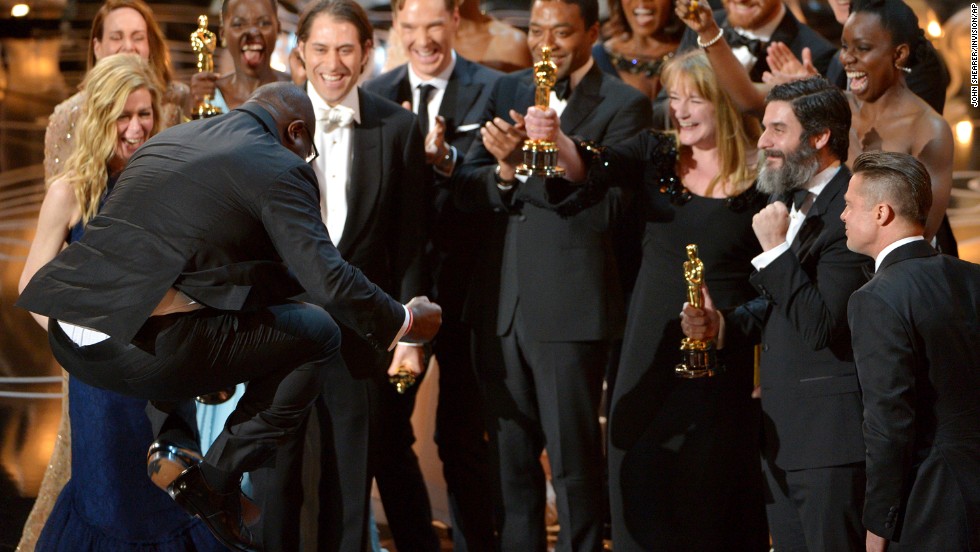 Director Steve McQueen, left, celebrates with the cast and crew of &quot;12 Years a Slave&quot; as they accept the Academy Award for best picture on Sunday, March 2.