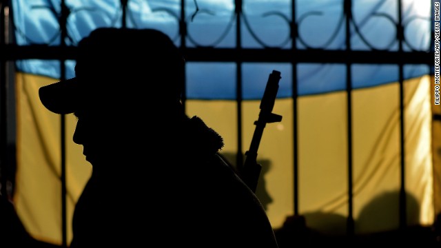 The silhouette of a Ukrainian soldier is seen against a Ukrainian flag as Ukrainian soldiers wait inside the Sevastopol tactical military brigade base in Sevastopol on March 3, 2014. Russian forces have given Ukrainian soldiers an ultimatum to surrender their positions in Crimea or face an assault, a Ukrainian defence ministry spokesman said. &#39;The ultimatum is to recognise the new Crimean authorities, lay down our weapons and leave, or be ready for an assault,&#39; said Vladyslav Seleznyov, the regional ministry spokesman for the Crimea. AFP PHOTO / FILIPPO MONTEFORTE (Photo credit should read FILIPPO MONTEFORTE/AFP/Getty Images)
