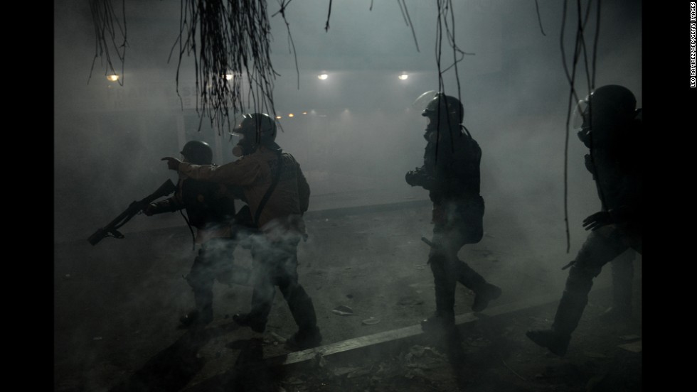 National Guard members throw tear gas canisters toward opposition activists in Caracas on March 3.