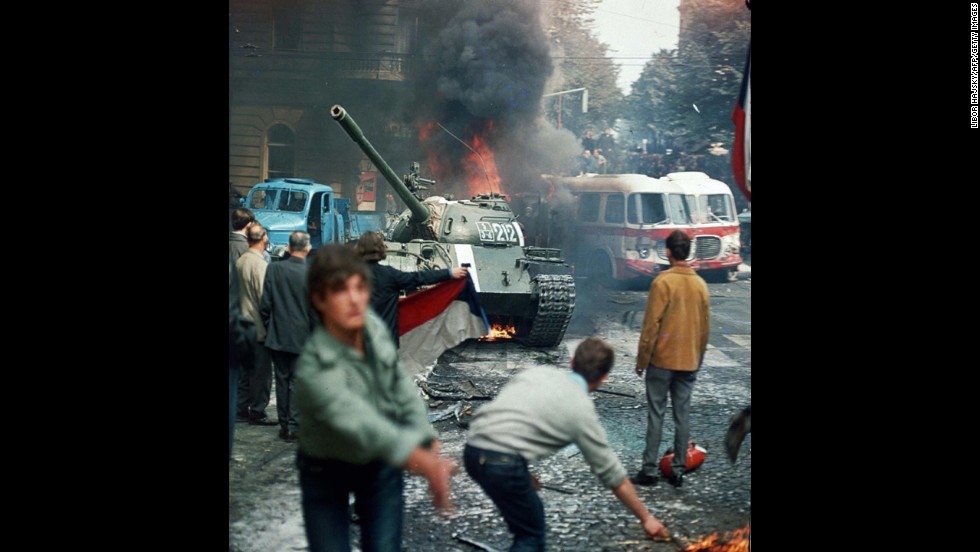 On January 5, 1968, reformer Alexander Dubcek became general secretary of the Communist Party in Czechoslovakia, pledging the &quot;widest possible democratizations&quot; as the Prague Spring movement swept across the country. Soviet and Warsaw Pact leaders sent an invasion force of 650,000 troops in August. Dubcek was arrested and hard-liners were restored to power. Here, residents carrying a Czechoslovak flag and throwing burning torches attempt to stop a Soviet tank in Prague on August 21, 1968. 
