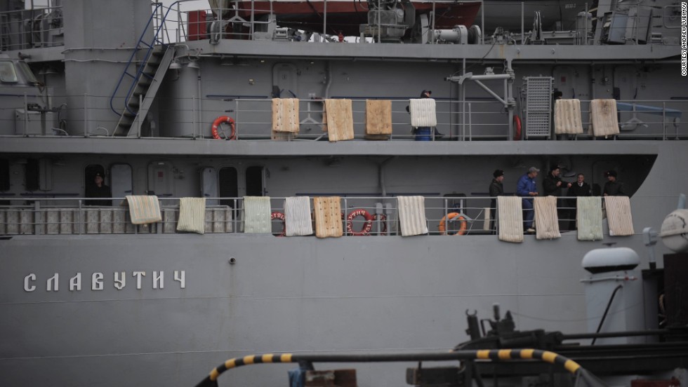 People stand on the Ukrainian Navy ship Slavutych while it&#39;s at harbor in Sevastopol on March 4. Mattresses were placed over the side of the ship to hinder any attempted assault.