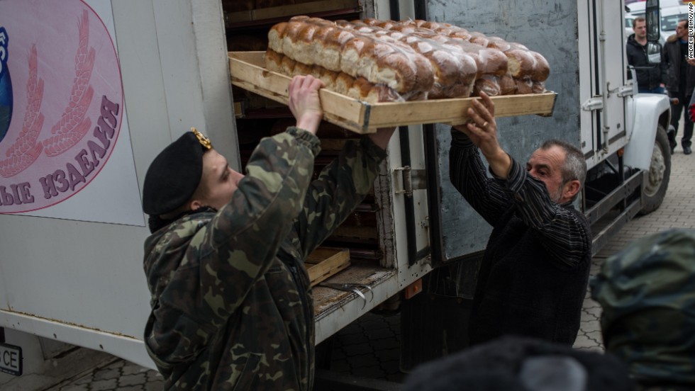 A soldier and a truck driver unload bread outside the Ukranian navy headquarters in Sevastopol on March 2.