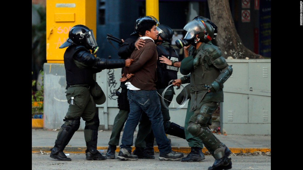 National Guard members detain a protester March 4 in Caracas.