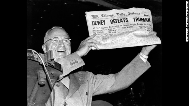 Harry Truman holds up the Chicago Daily Tribune  with a headline of his &quot;defeat&quot; to Thomas Dewey in 1948.