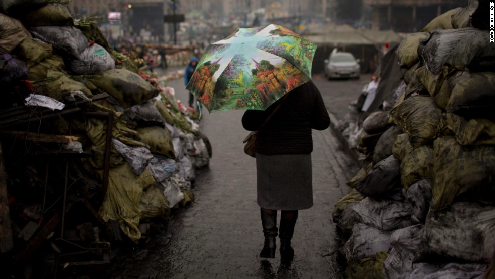 A woman walks past barricades March 6 that were set up by anti-government protesters in Kiev&#39;s Independence Square.