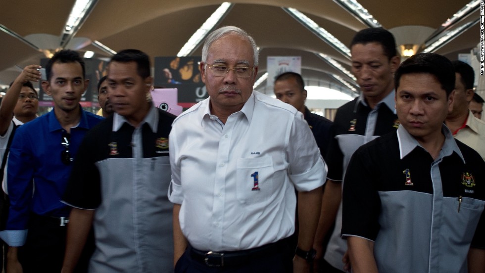 Malaysian Prime Minister Najib Razak, center, arrives to meet family members of missing passengers at the reception center at Kuala Lumpur International Airport on March 8, 2014.
