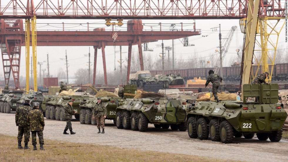 Ukrainian soldiers load armored personnel carriers into boxcars in the western Ukrainian city of Lviv on March 8.