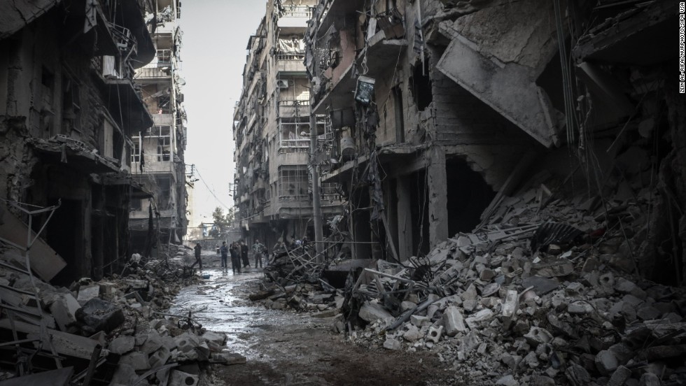 Syrians inspect the rubble of destroyed buildings in Aleppo following a reported airstrike by Syrian government forces on Friday, March 7.