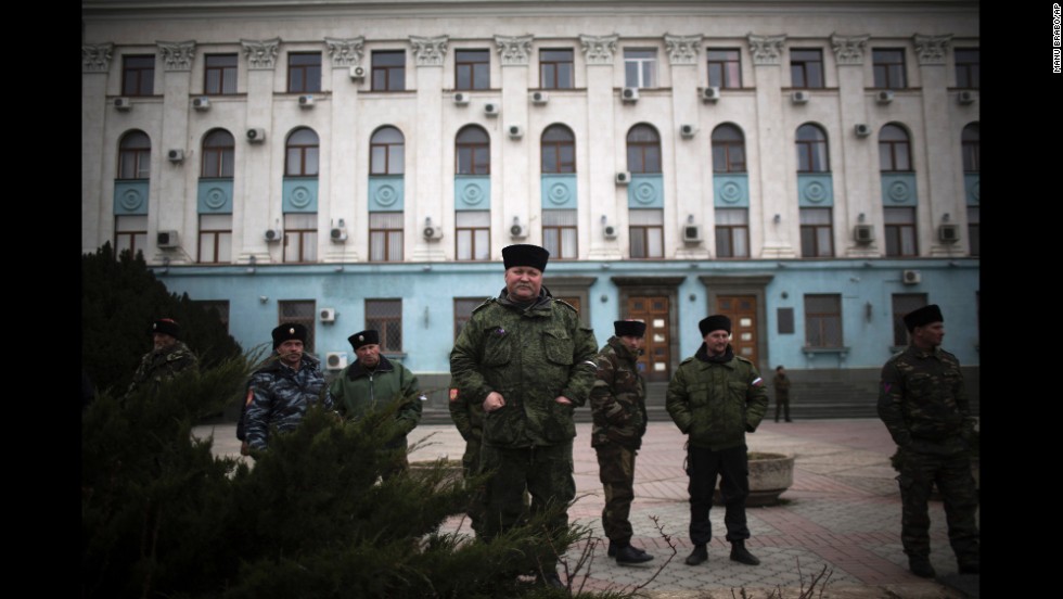 Cossacks and other pro-Russian forces stand guard outside a government building in Simferopol on Saturday, March 8.