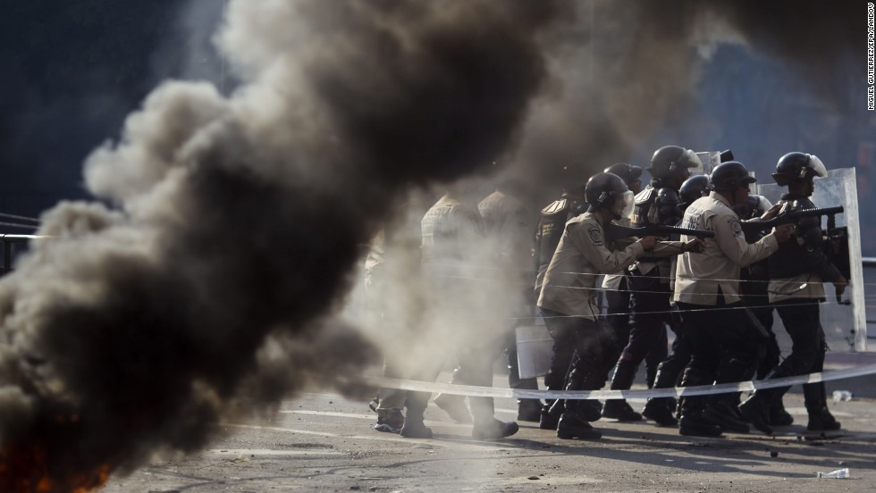 Police keep formation during protests against the government in Caracas on Saturday, March 8.