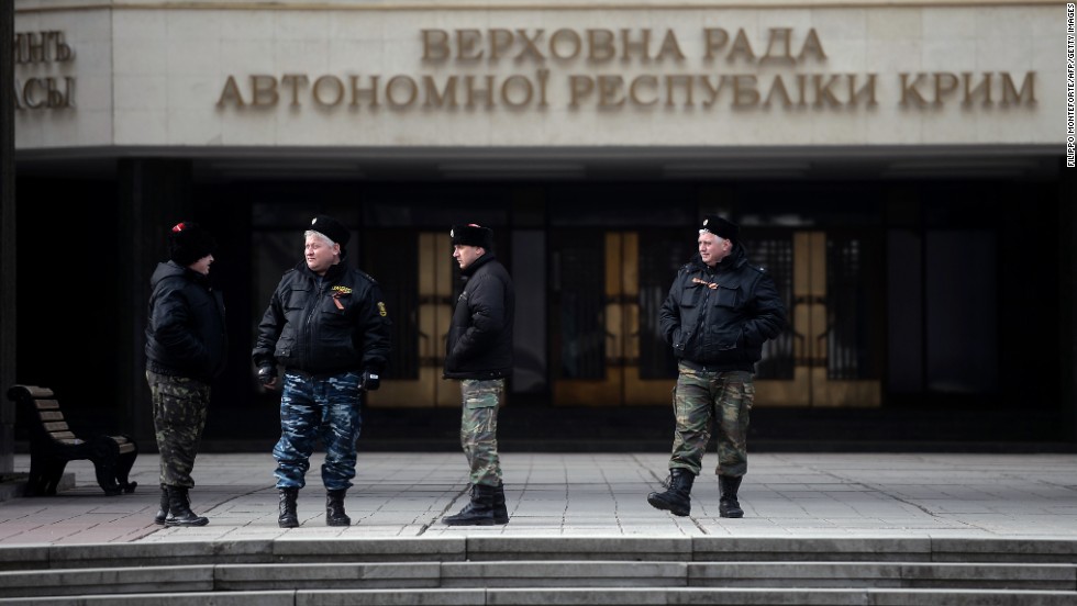 Cossacks stand guard at Crimea&#39;s regional parliament building in Simferopol on March 12.