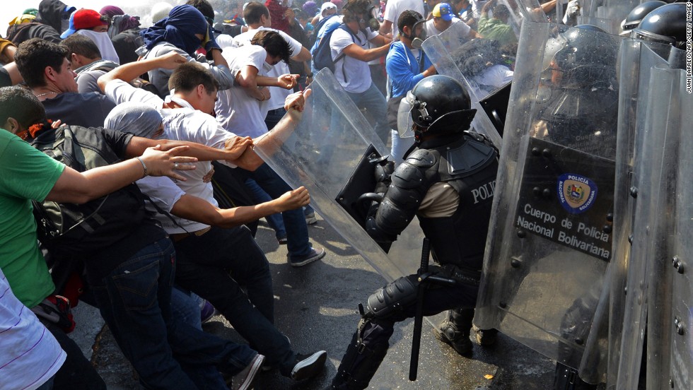 Venezuelan students clash with riot police during a protest against the government on Wednesday, March 12.