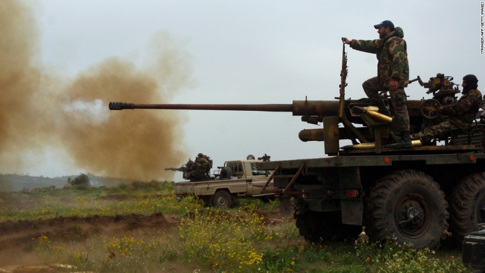 Syrian forces fire a cannon and a heavy machine gun loaded on a truck as they fight rebels in the Syrian town of Zara on Saturday, March 8. 