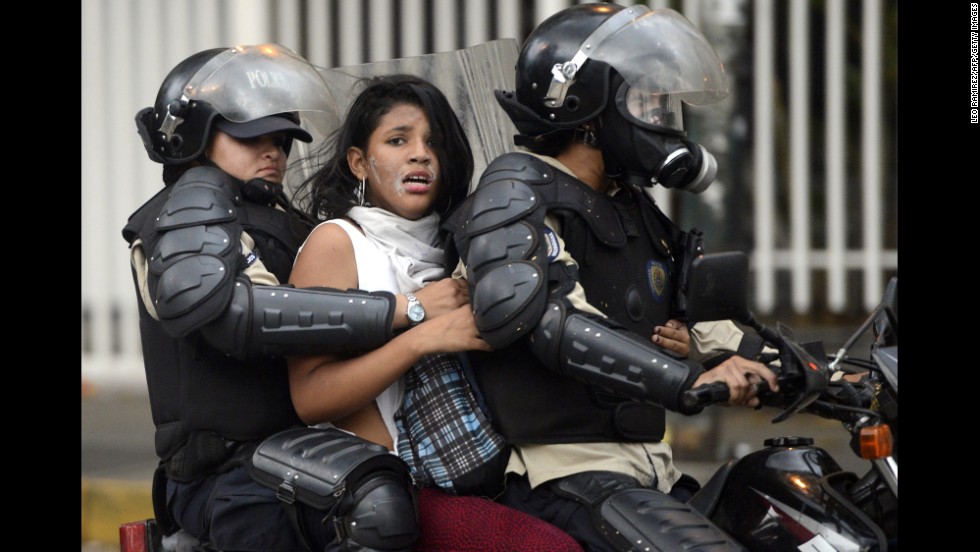 An activist is taken by police during an anti-government protest in Caracas on March 13.