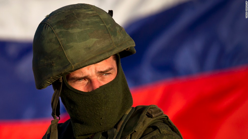 A pro-Russian soldier, with the Russian flag behind him, mans a machine gun outside an Ukrainian military base in Perevalne on Saturday, March 15.