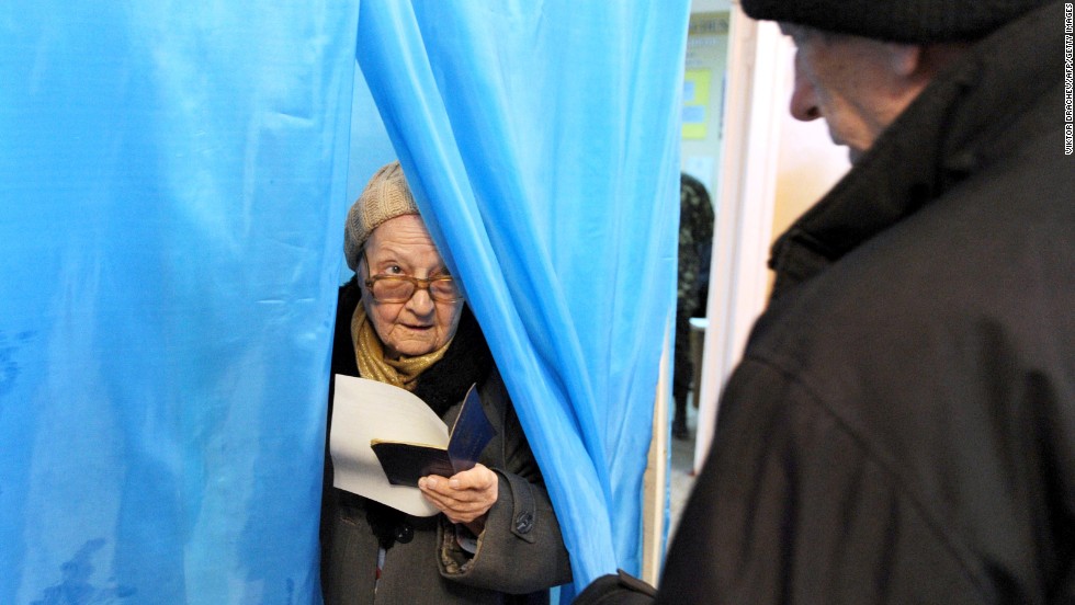 A woman leaves a voting booth in Sevastopol, Ukraine, on Sunday, March 16.  Polls opened Sunday morning in a referendum in Ukraine&#39;s Crimea region, in which voters are to voice their wish to either join Russia or become an effectively independent state connected to Ukraine.
