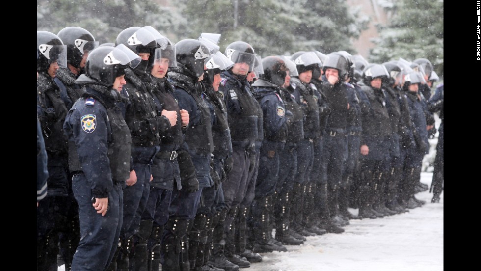 Policemen stand guard outside the regional state administration building in Donetsk during a rally by pro-Russia activists March 17.