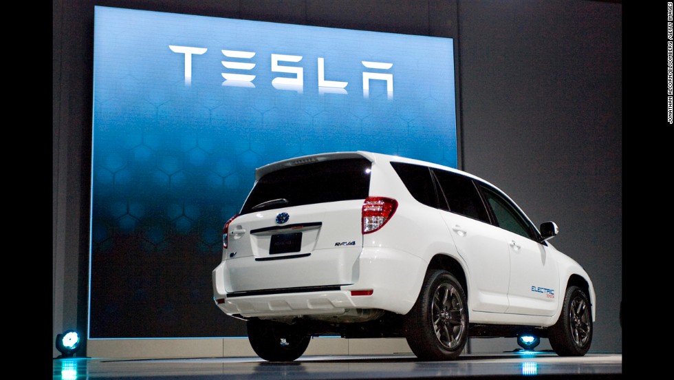 Tesla RAV4 EV is displayed at an auto show. 