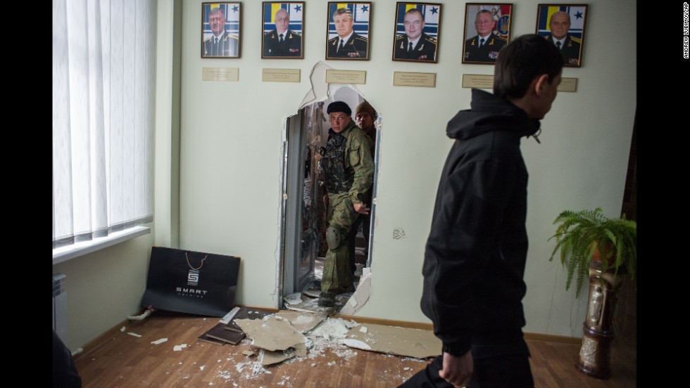 Pro-Russian forces walk inside the Ukrainian navy headquarters in Sevastopol on March 19.