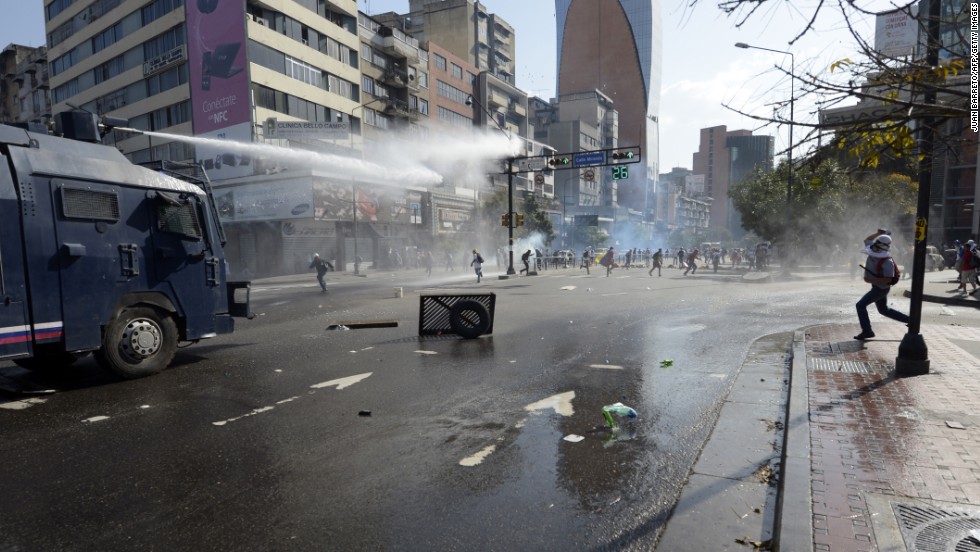 Law enforcement personnel use water cannons to disperse demonstrators on March 22.  