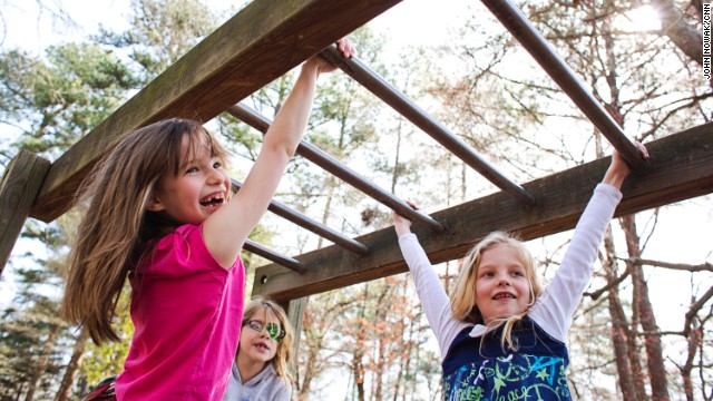 Students swing from the monkey bars at Hess Academy in Decatur, Georgia. The private school gives kids opportunities to stay active throughout the day.