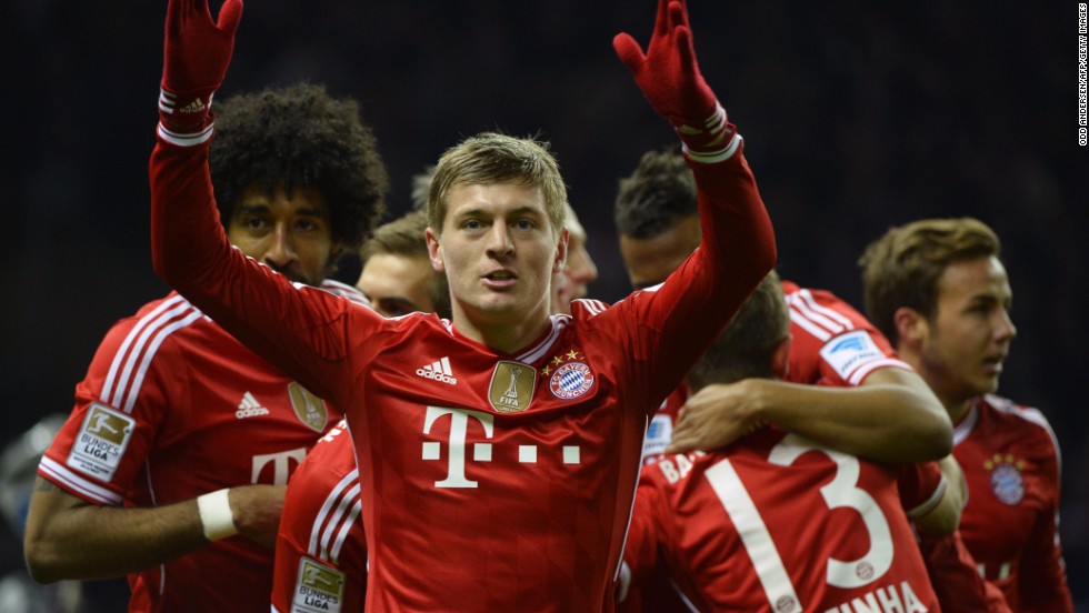 Toni Kroos (center) celebrates scoring Bayern Munich&#39;s opening goal against Hertha Berlin which helped seal a 24th Bundesliga title for the Bavarians. 