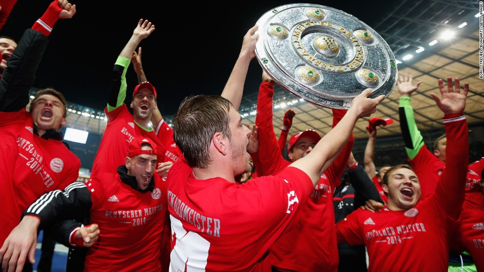 Bayern Munich&#39;s players celebrate with a replica of Bundesliga championship trophy after clinching the title at the Olympic Stadium in Berlin.