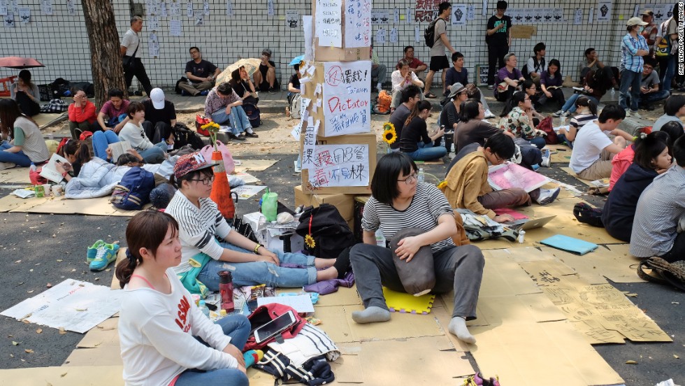 Protesters who oppose the trade agreement sit outside the Legislature during a demonstration in Taipei on Wednesday, March 26.