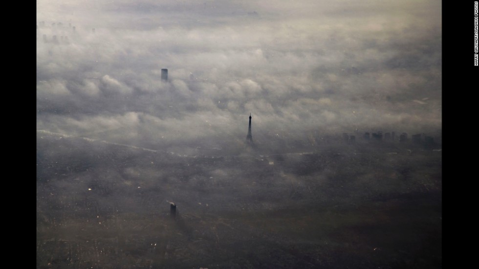 The Eiffel Tower peeks above the morning fog in 2005. 