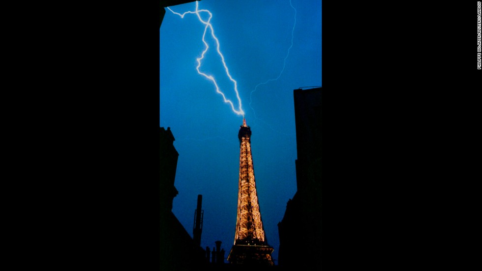A lightning bolt strikes the top of the Eiffel Tower during a thunderstorm in 1992.