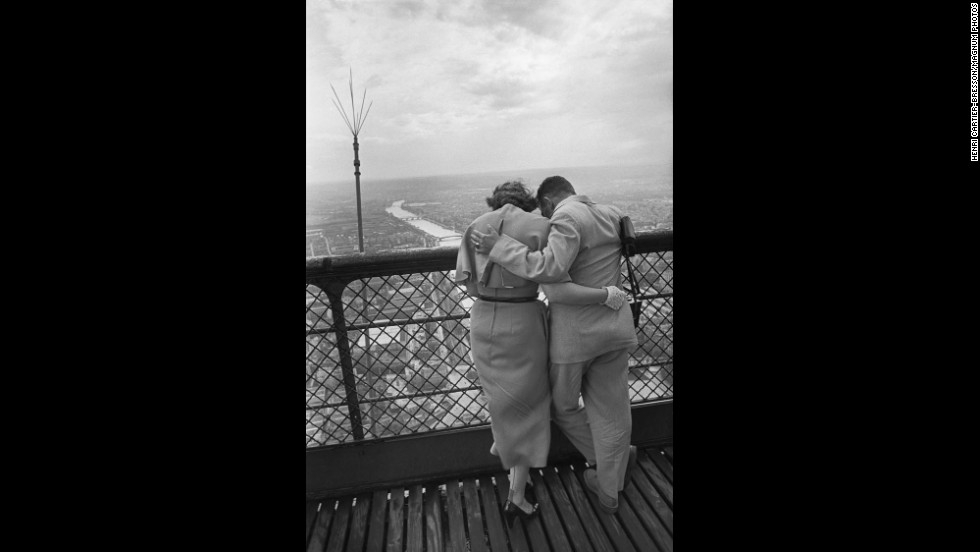 A couple enjoys the view from the Eiffel Tower in 1952. More than 250 million visitors have been to the tower since its construction in 1889.