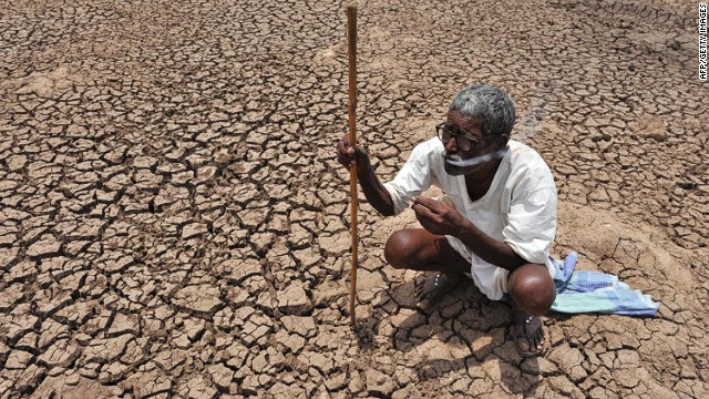 In this file photo taken on June 7, 2010, an Indian shepherd rests in the dry lakebed of Osman Sagar Lake, commonly known as Gandipet, on the outskirts of Hyderabad.