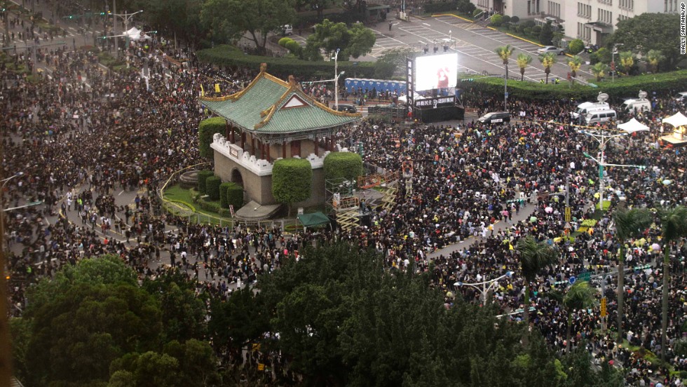 Thousands of demonstrators gather in front of the Presidential Building to protest the trade deal Sunday, March 30, in Taipei.