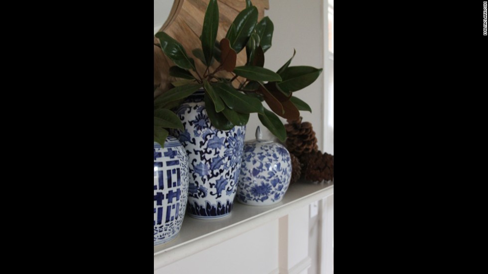 Blue chinoiserie ginger jars are a recent evolution of Clark&#39;s love of blue decor. Magnolia branches and pine cones in addition to the jars bring organic texture to her mantle.