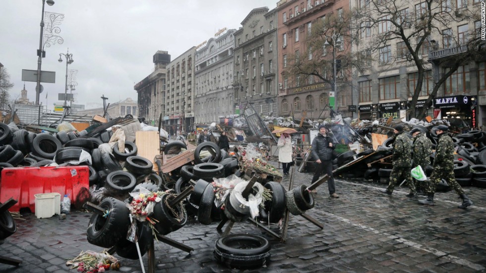 People pass by barricades near the Dnipro Hotel in Kiev on April 1. 