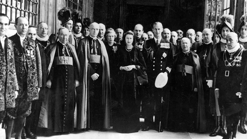 The Queen, then as Princess Elizabeth, poses for a group photo with her entourage, Vatican knights and Swiss Guards following a talk with Pope Pius XII in April 1951.