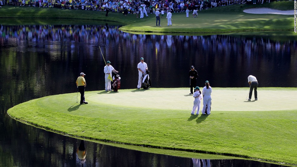 Palmer putts as fellow greats Jack Nicklaus (left) and Gary Player (center) look on during the Par 3 Contest prior to the 2011 Masters at the course the American called &quot;a pleasure to play on.&quot; 