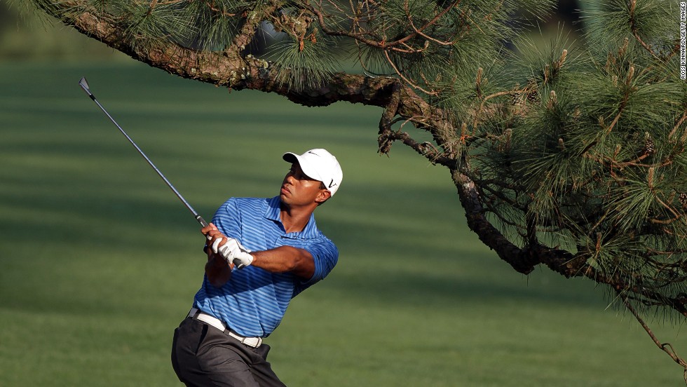 Tiger Woods plays a shot under the Eisenhower Tree at the 2011 Masters, suffering an injury that would cause him to miss four months of the season. 