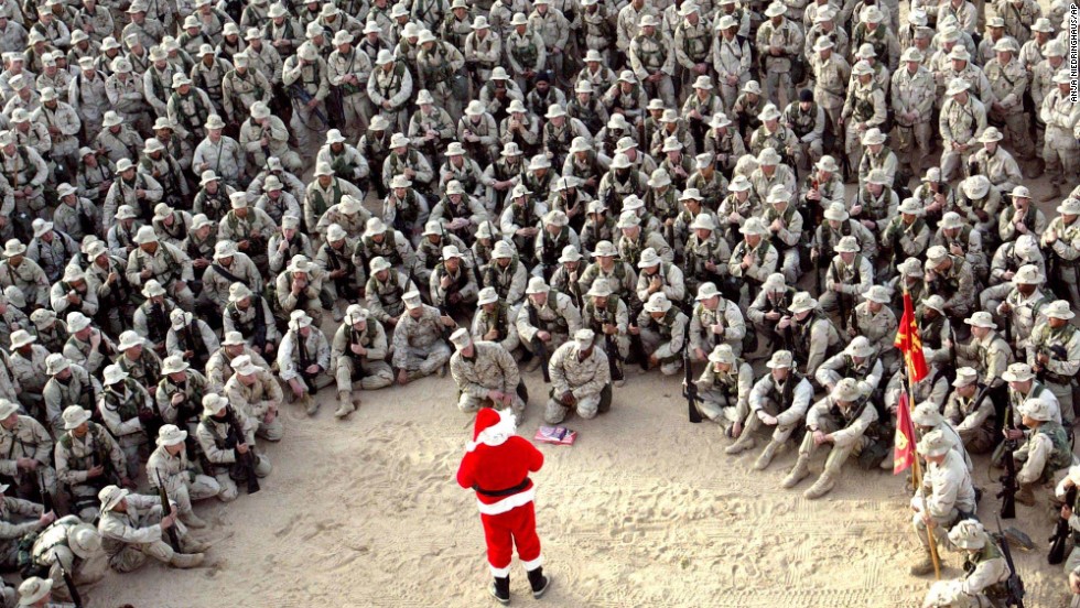Hundreds of U.S. Marines gather at Camp Commando in the Kuwaiti desert during a Christmas Eve visit by Santa Claus in 2002.