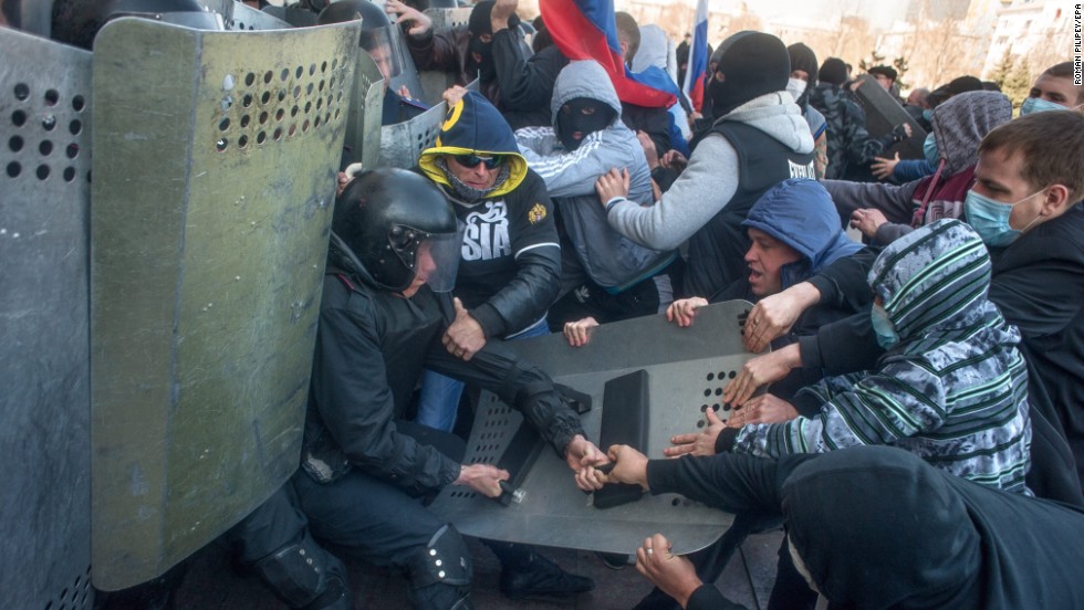 Pro-Russian protesters clash with police as they try to occupy a regional administration building in Donetsk on April 6. 