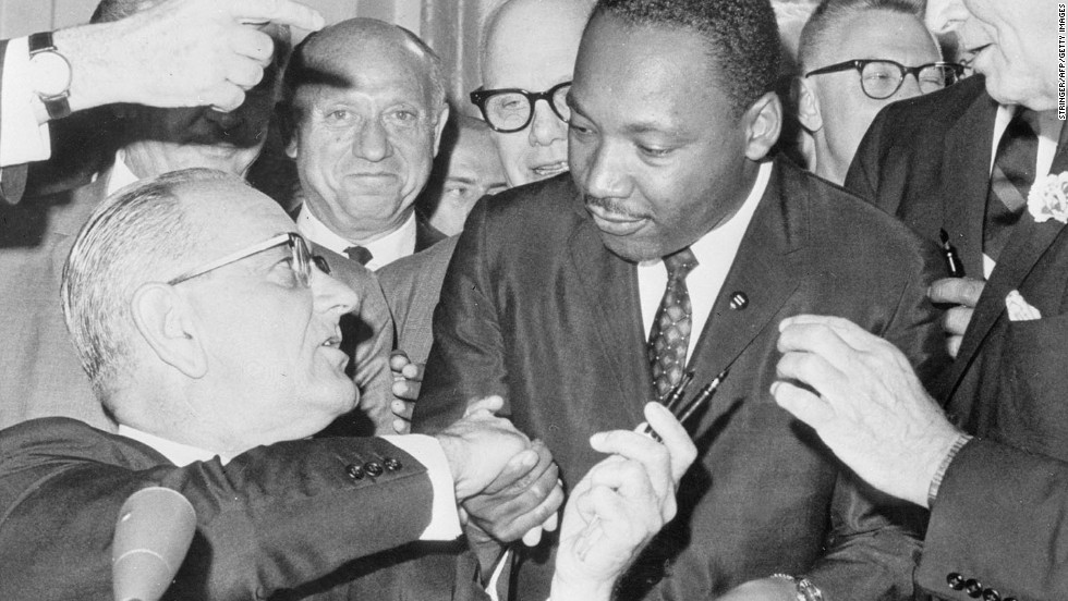 President Lyndon B. Johnson shakes hands with civil rights leader Martin Luther King Jr. after signing the Civil Rights Act of 1964. The LBJ Presidential Library is hosting a Civil Rights Summit this week to mark the 50th anniversary of the legislation.