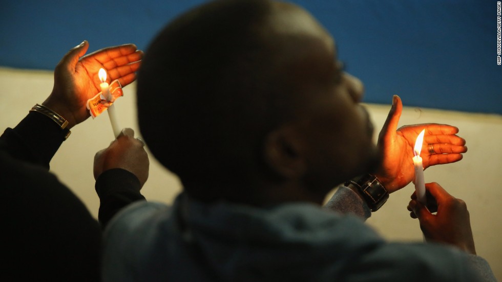 People hold a candlelight vigil at Amahoro Stadium in Kigali on April 7 during a ceremony marking the anniversary of the genocide.