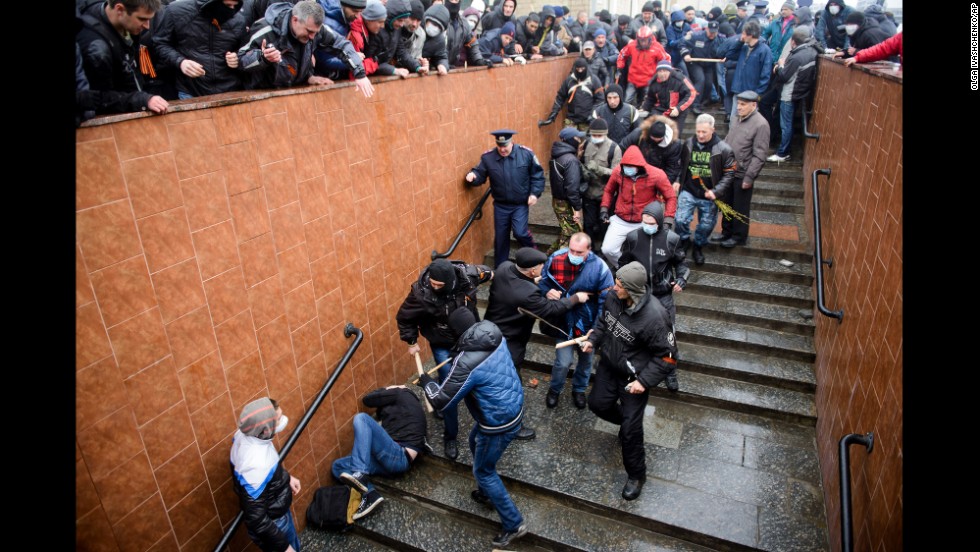 Pro-Russian supporters beat a pro-Ukrainian activist during a rally in Kharkiv on Sunday, April 13.
