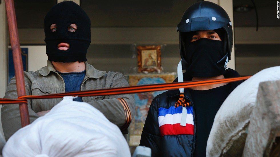 Masked pro-Russian protesters stand guard in front of the city hall in Mariupol on April 17.