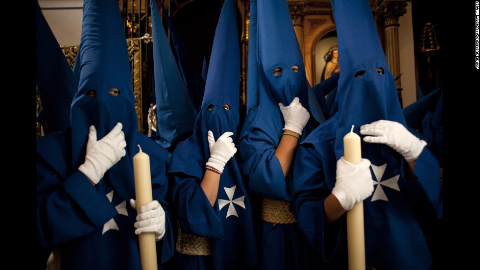 Penitents take part in the Fusionadas brotherhood procession in Malaga, Spain, on April 16.