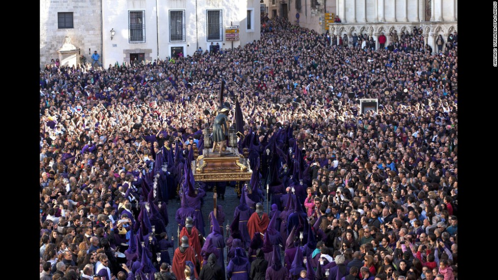 Penitents, surrounded by several thousand people in Cuenca, Spain, carry a statue of Our Father Nazarene during the Good Friday procession &quot;Way of Calvary.&quot;