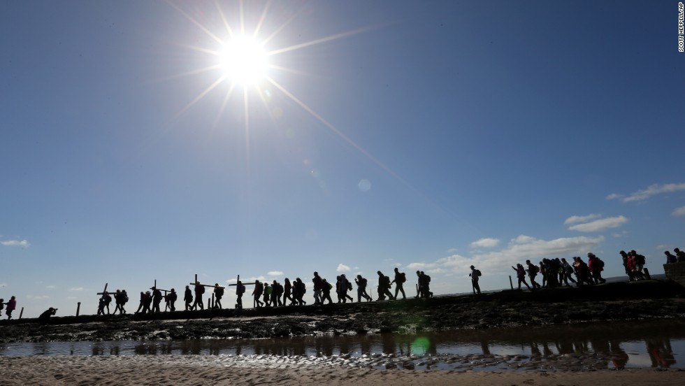 People walk with crosses April 18 as the Northern Cross pilgrimage makes the final leg of its journey to Holy Island, England.